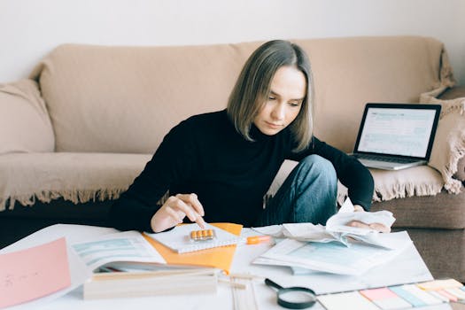 a person budgeting with a calculator and notebook