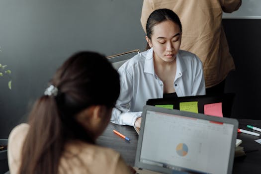 A person looking at a laptop with a financial app