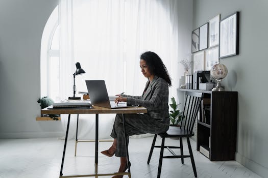 A young adult creating a budget on a laptop