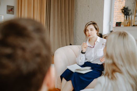 A couple in a group coaching session taking notes