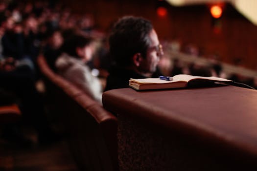 person writing in a notebook while listening to a podcast