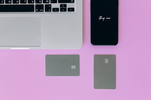 person holding a credit card and a smartphone